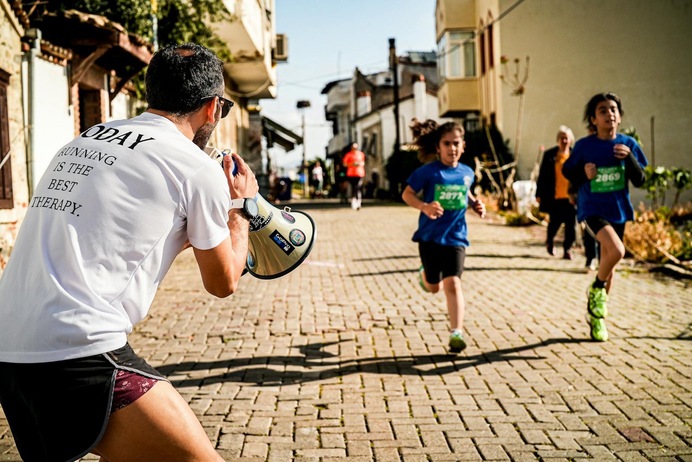 children running a street race while a